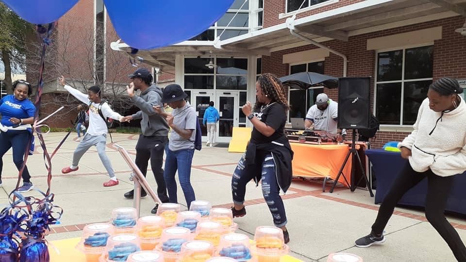 Church members dancing outdoors during a community event.