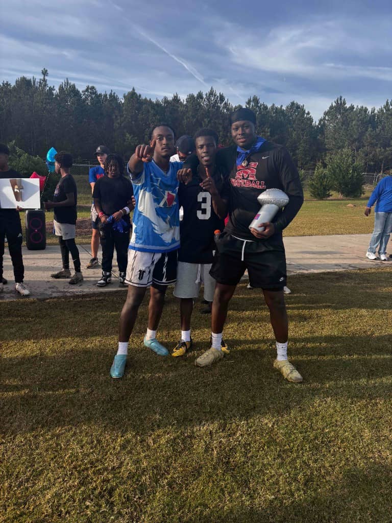 Young men connecting at an outdoor fellowship football event.