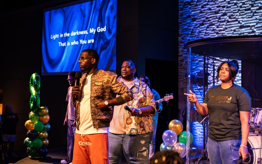 Worship team leading with the church engaged in service.