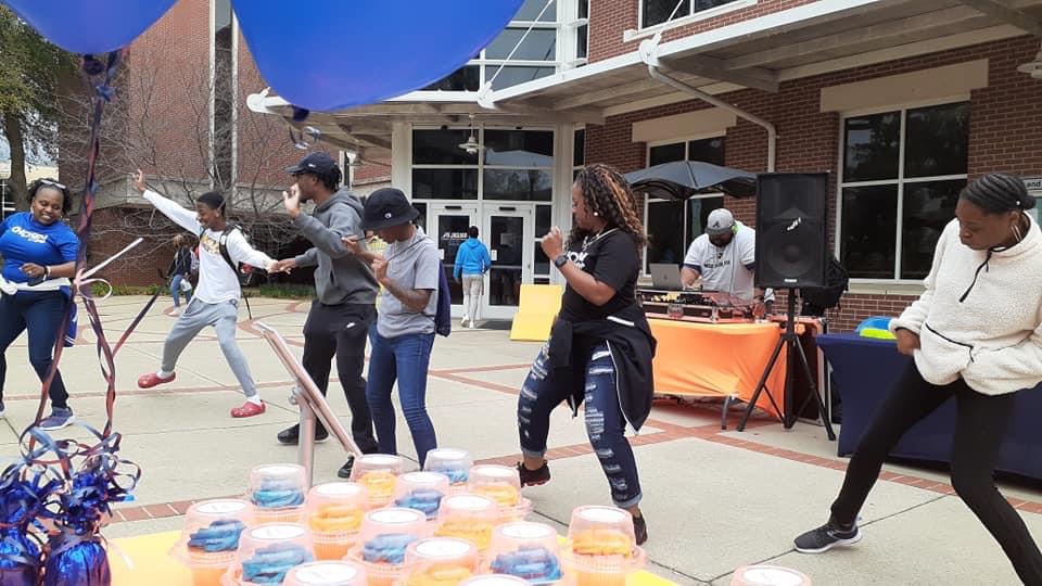 Church members dancing outdoors during a community event.