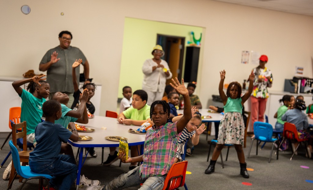 Children waving and smiling during Chosen Kids programming.