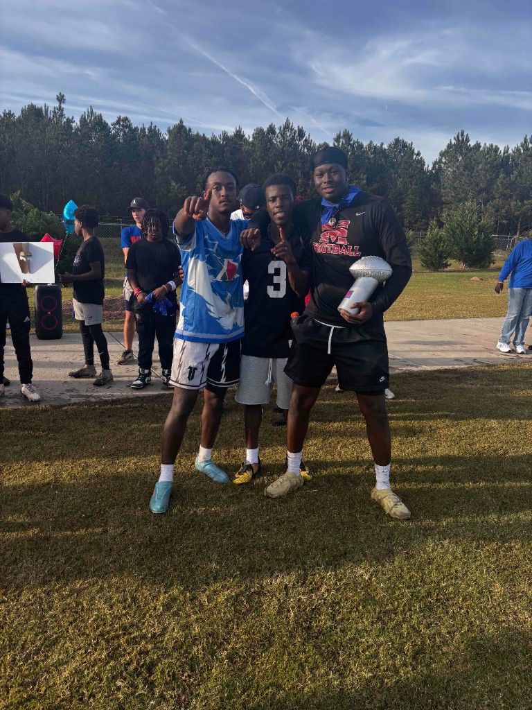 Young men connecting at an outdoor fellowship football event.